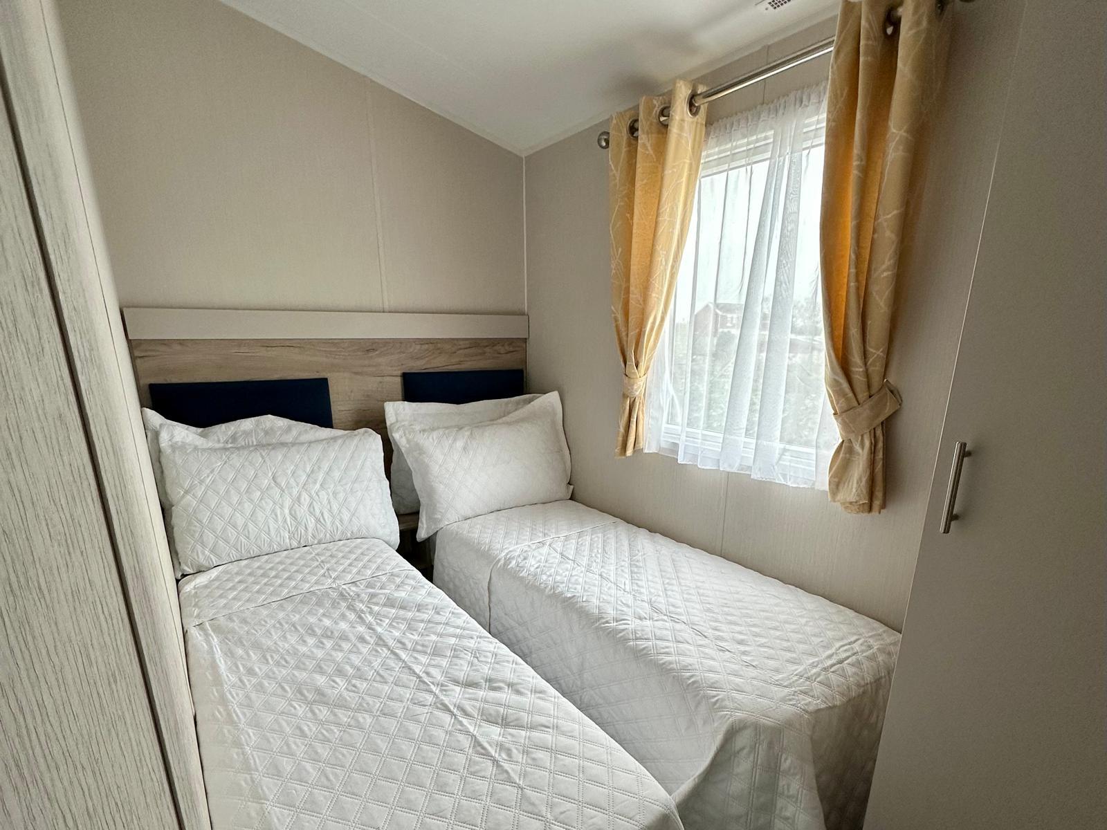 Twin bedroom with two single beds in the Willerby Linwood 2022 caravan at Windy Harbour Holiday Park