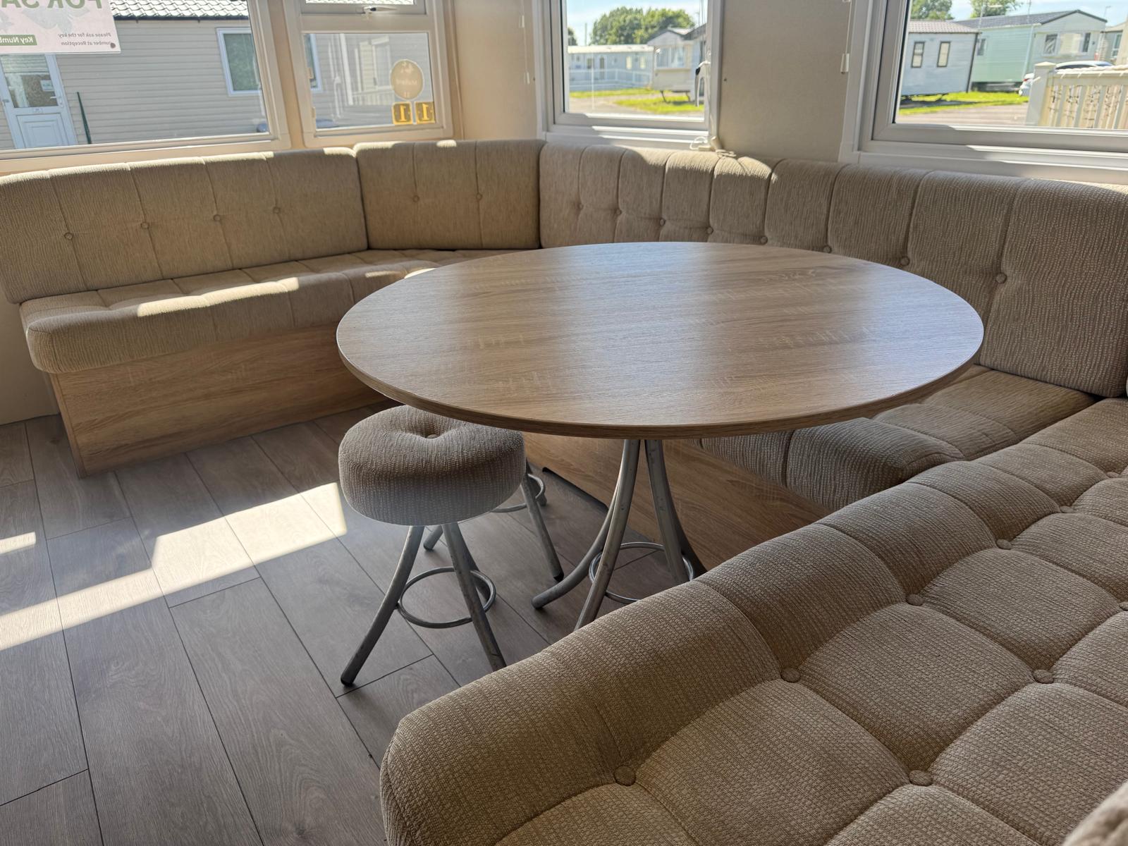 Living area with table and chairs in the Delta Santana caravan at Windy Harbour Holiday Park