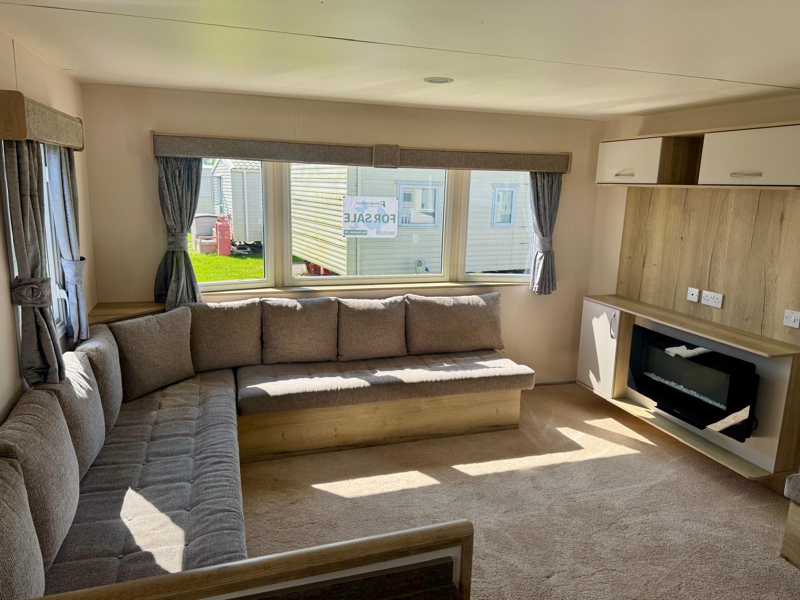 Living area and fireplace in the aBI Horizon 2019 caravan at Windy Harbour Holiday Park