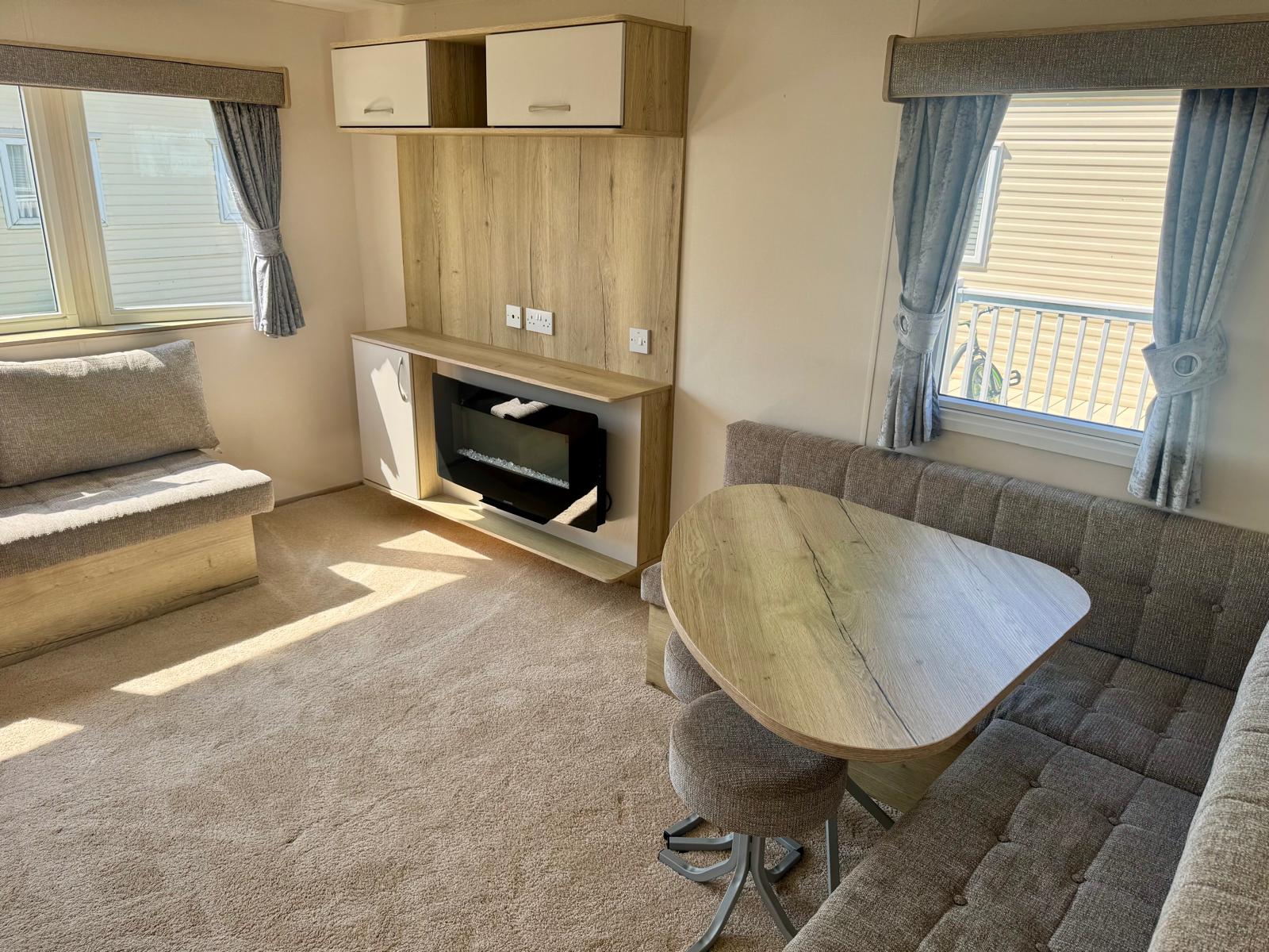 Living area and fireplace in the aBI Horizon 2019 caravan at Windy Harbour Holiday Park