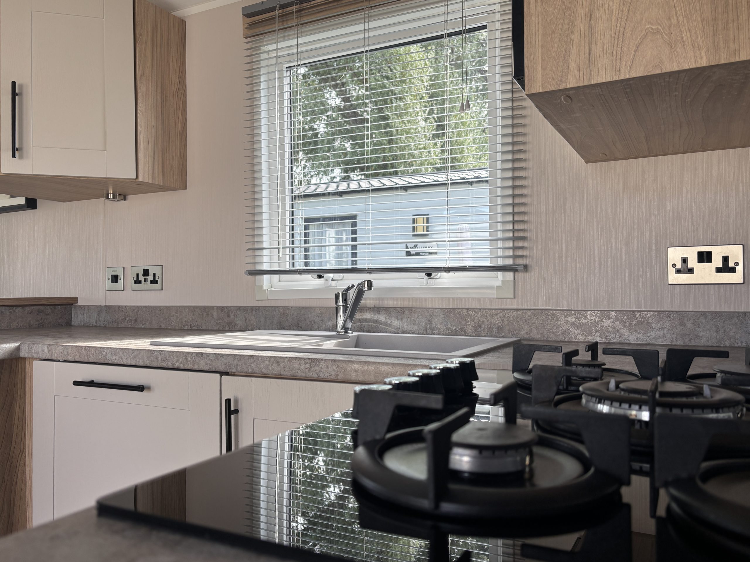 Kitchen area in the Willerby Manor 2023 caravan on Riverside 3 at Windy Harbour Holiday Park
