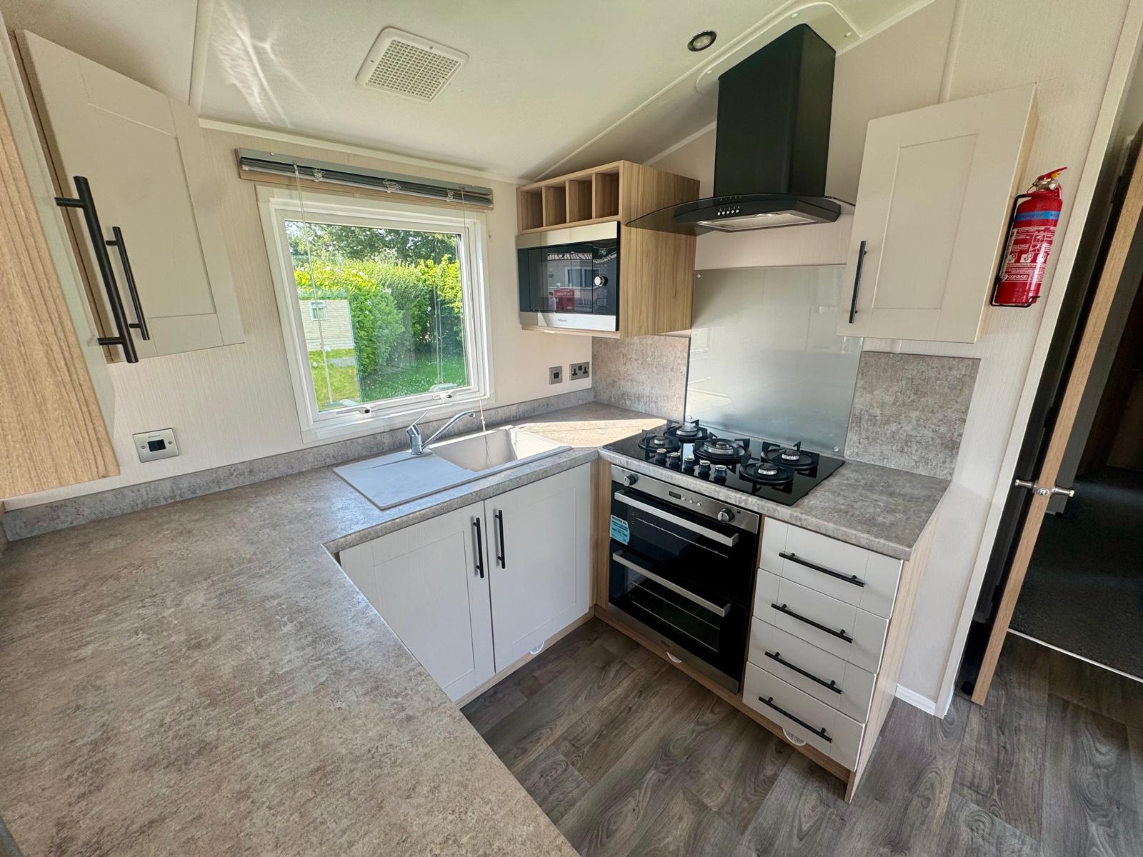 Open plan kitchen in the Willerby Manor 2023 caravan at Windy Harbour Holiday Park