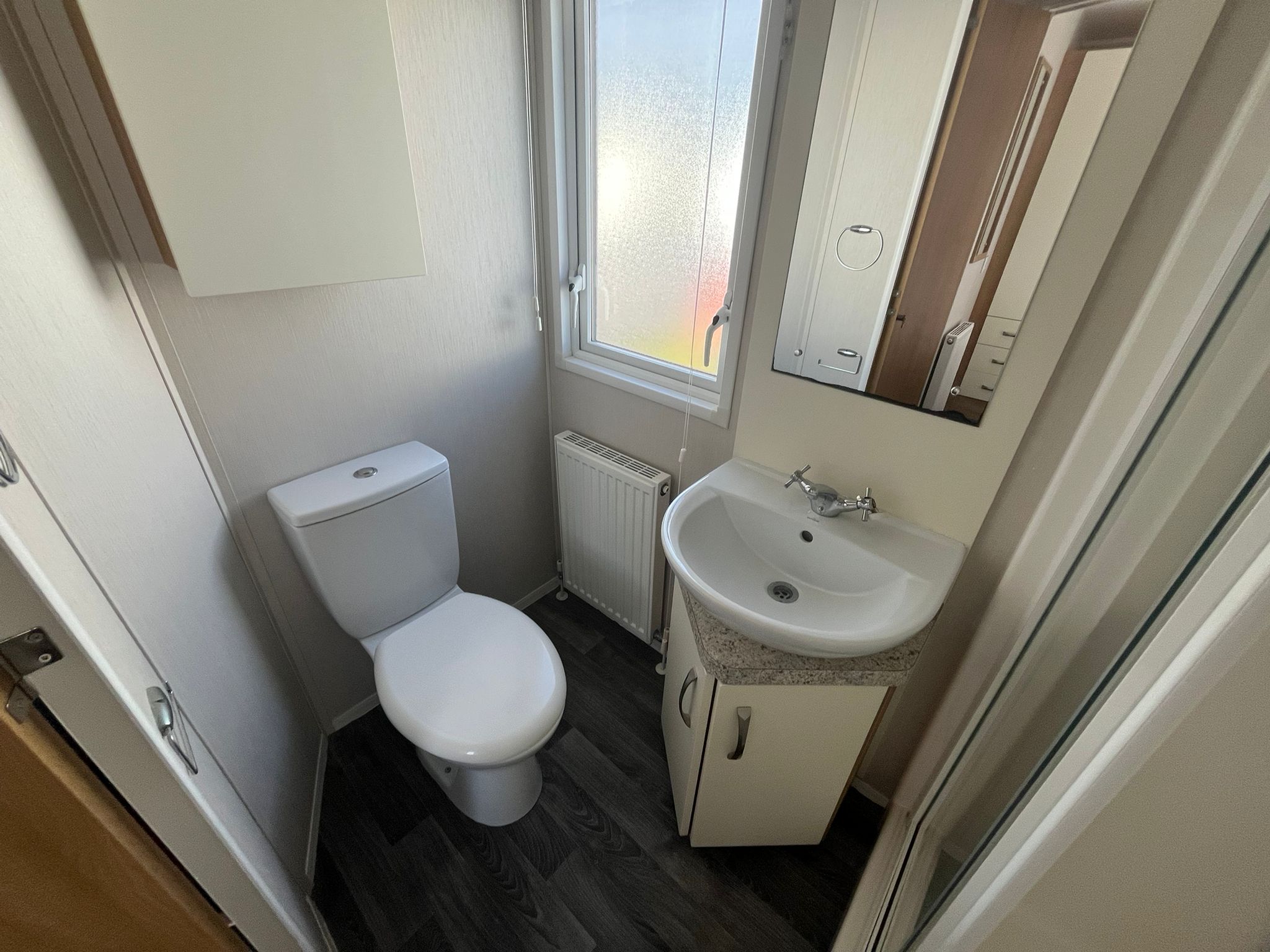 Family bathroom featuring white sink and vanity unit above