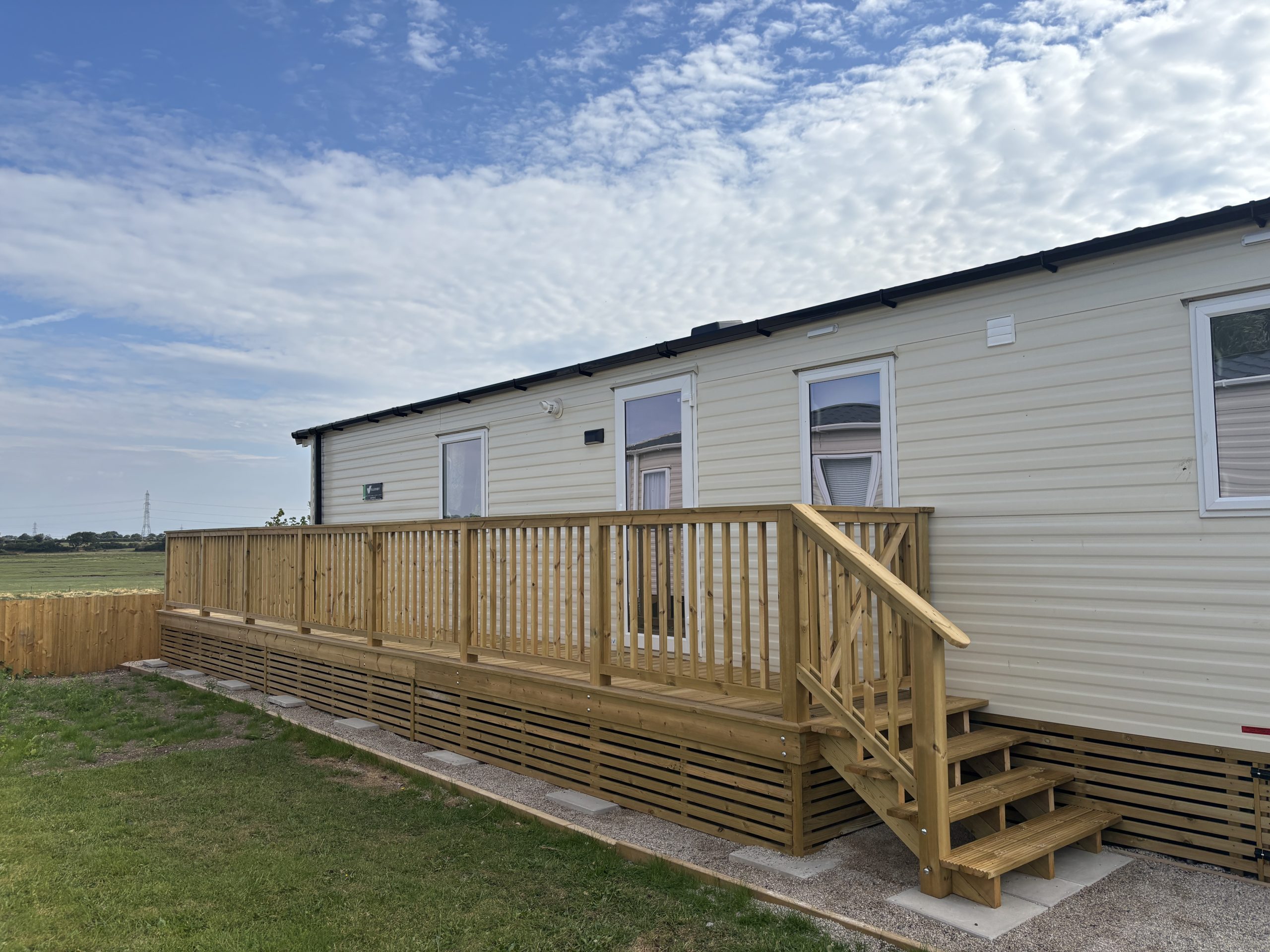 External shot of the Willerby Ashcroft showcasing it's decking at Windy Harbour Holiday Park