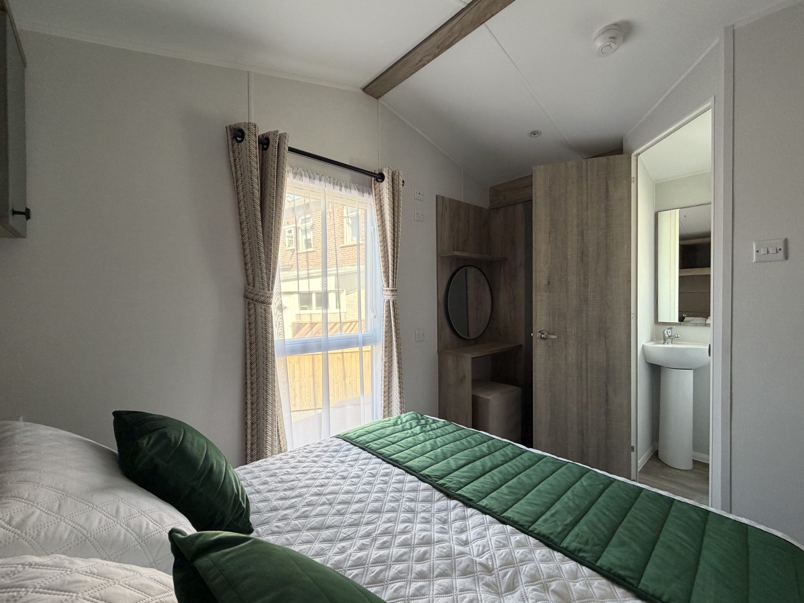 Master bedroom showing the large window and door through to the en suite