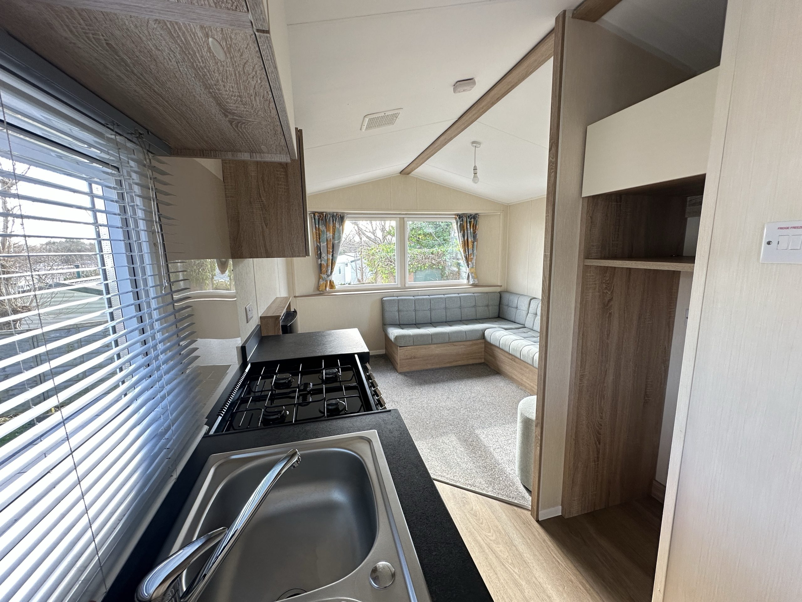 Kitchen and sink with window overlooking the sink in the Willerby Mistral caravan at Windy Harbour Holiday Park