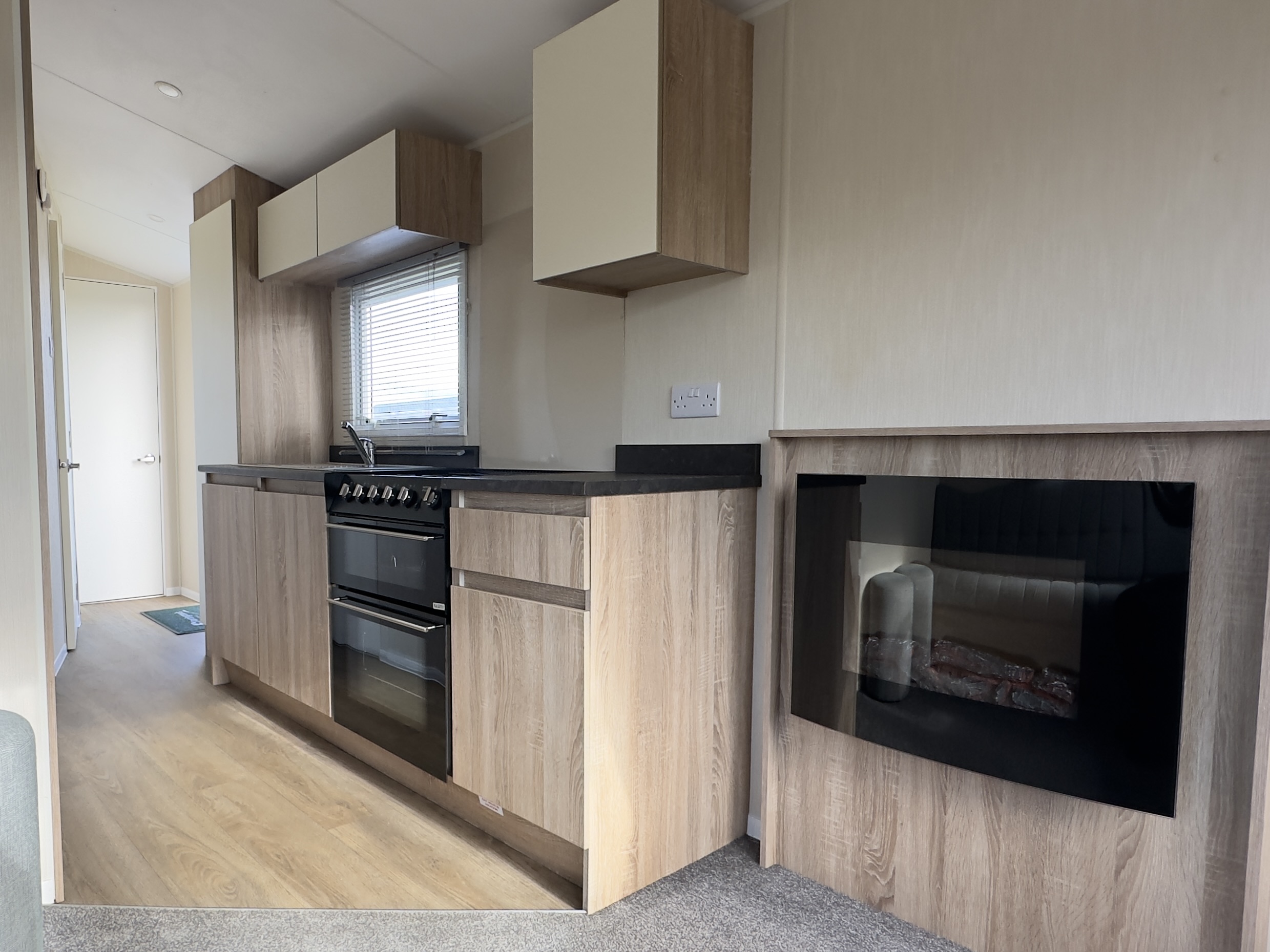 Gally kitchen and electric fire in the Willerby Mistral 2021 at Windy Harbour Holiday Park