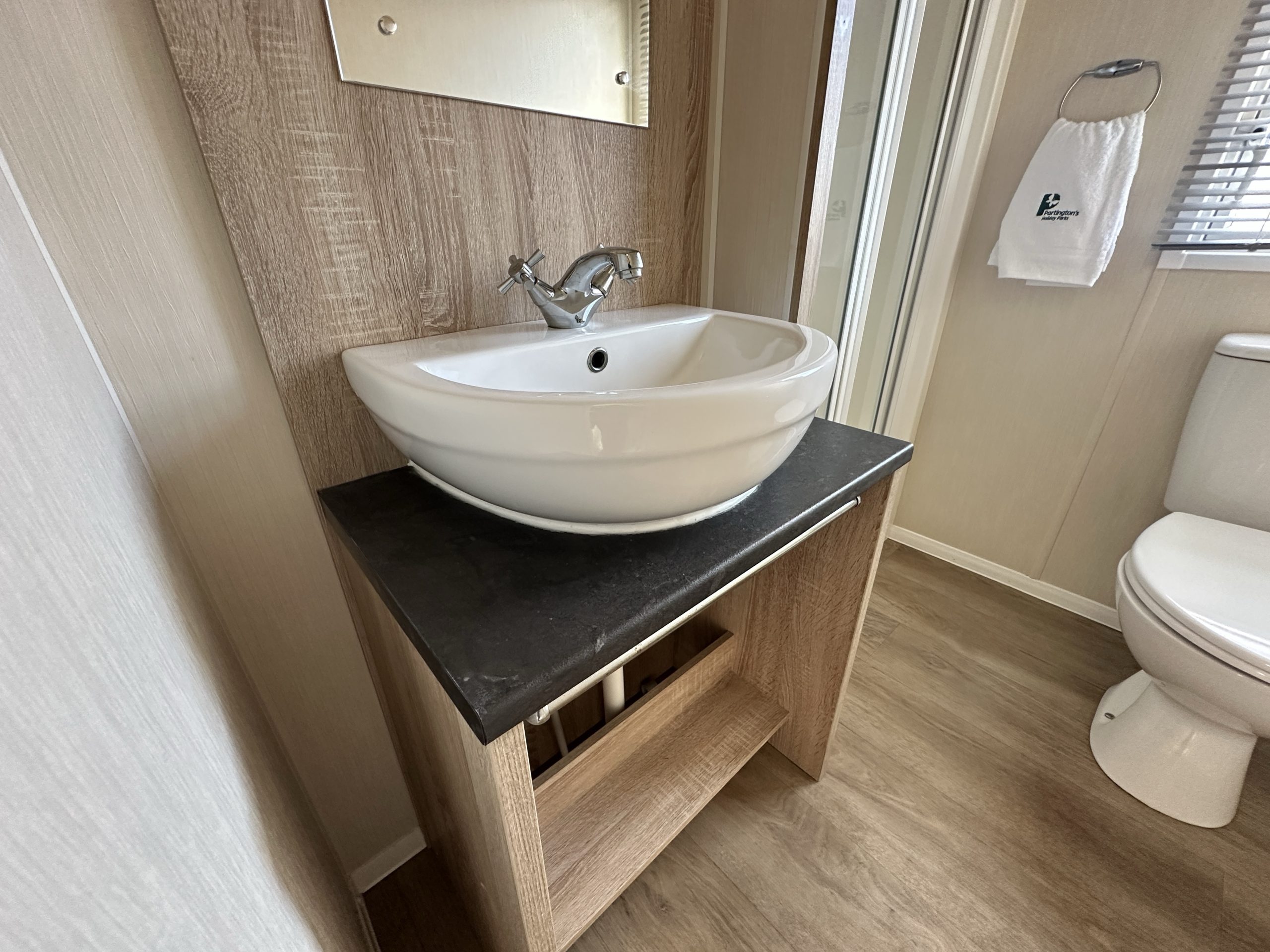 Bathroom fitted sink and storage unit in the Willerby Mistral 2021 caravan at Windy Harbour Holiday Park