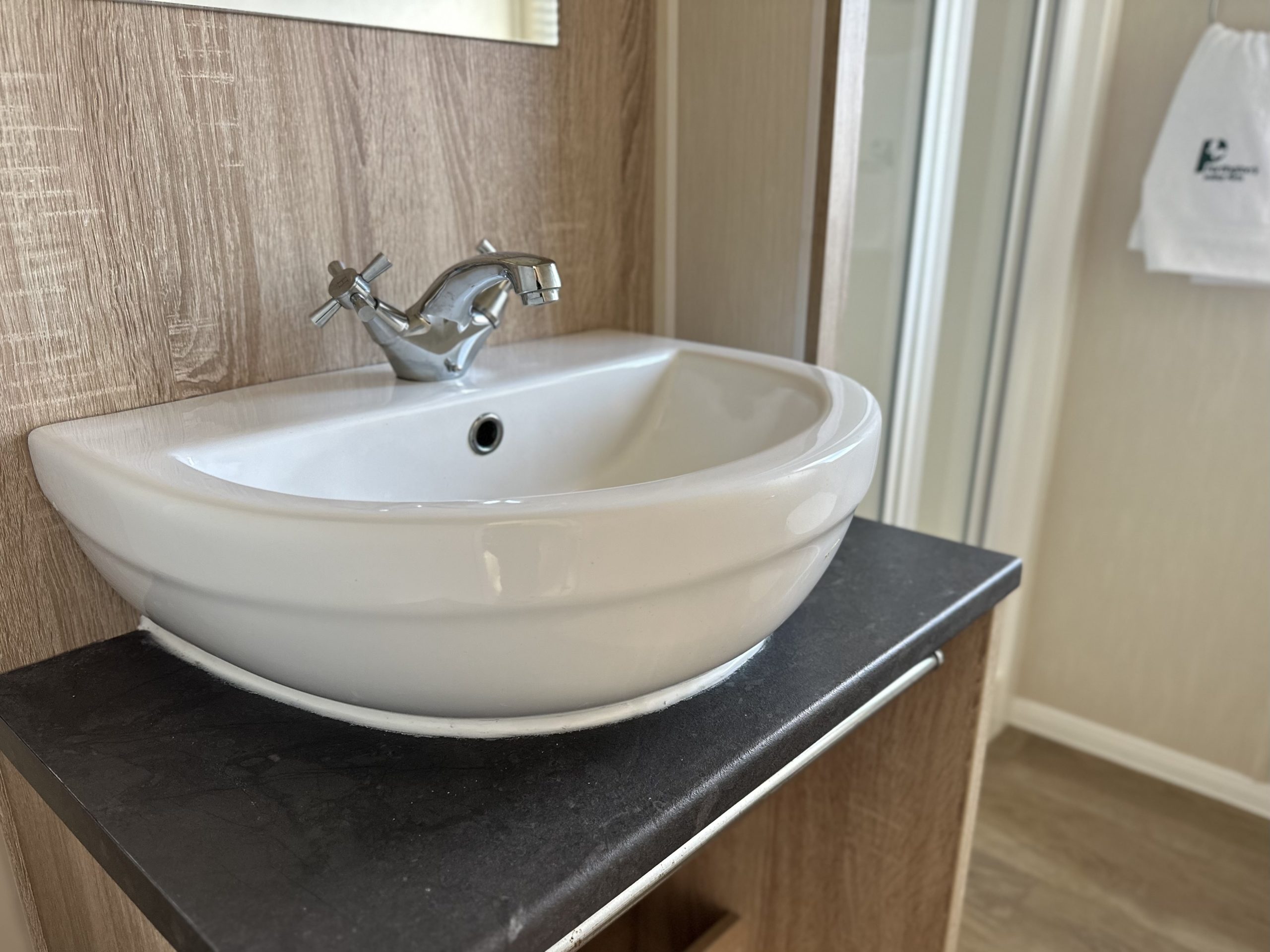 Close up photograph of the sink in the family bathroom in Willerby Mistral 2021 caravan at Windy Harbour Holiday Park