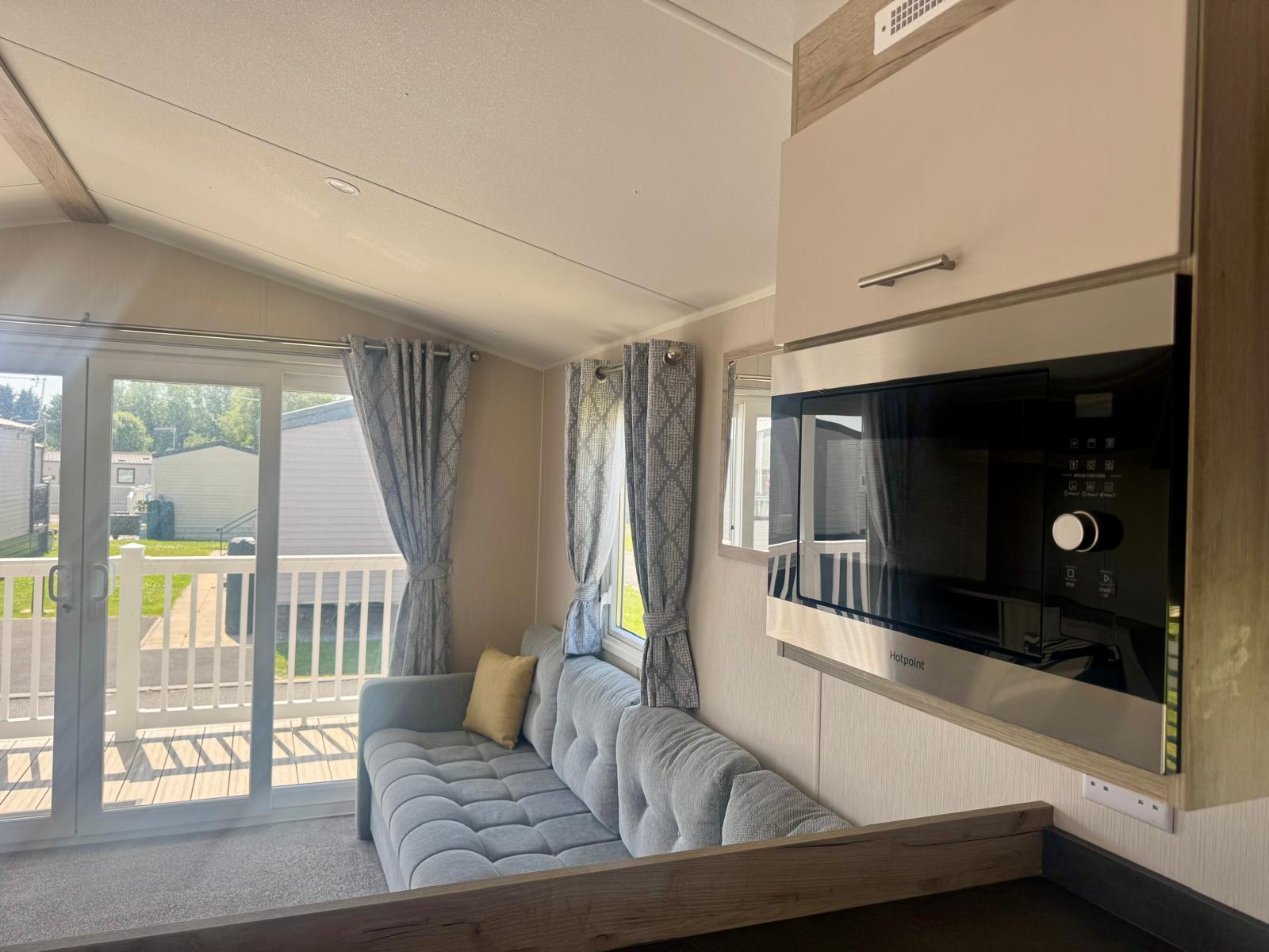 Fitted microwave in the kitchen in Willerby Linwood 2022 caravan at Windy Harbour Holiday Park