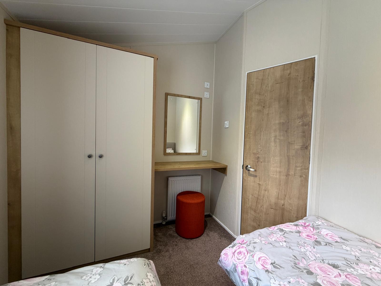 Image of the vanity area and double wardrobe in the first twin room in the Willerby Portland 2017 at Windy Harbour, a Partington's Holiday Park