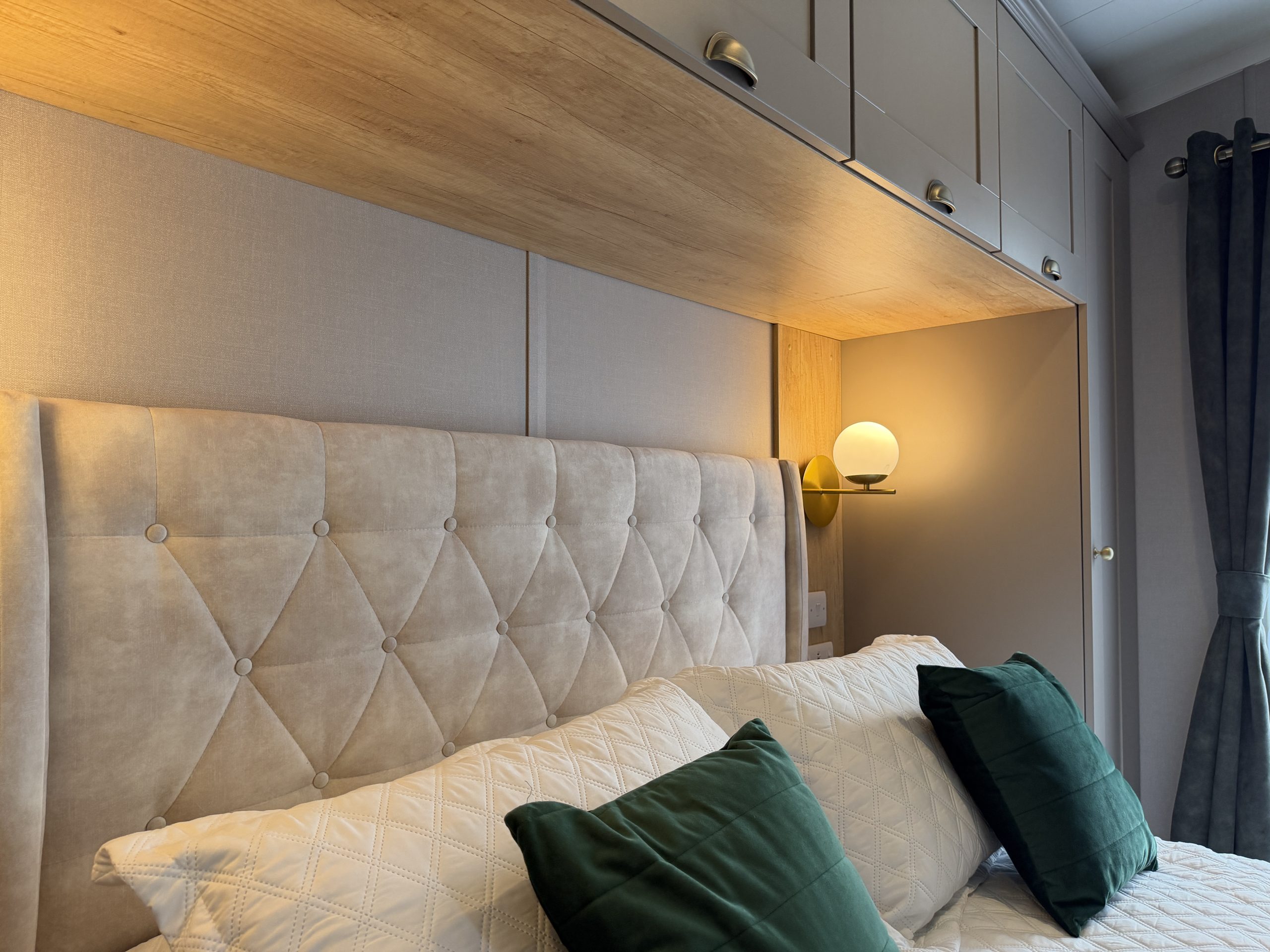 Detail shot of the headboard and overhead storage in the Master bedroom in the Swift Vendee Lodge 2026 at Broadwater Holiday Park, Partington's