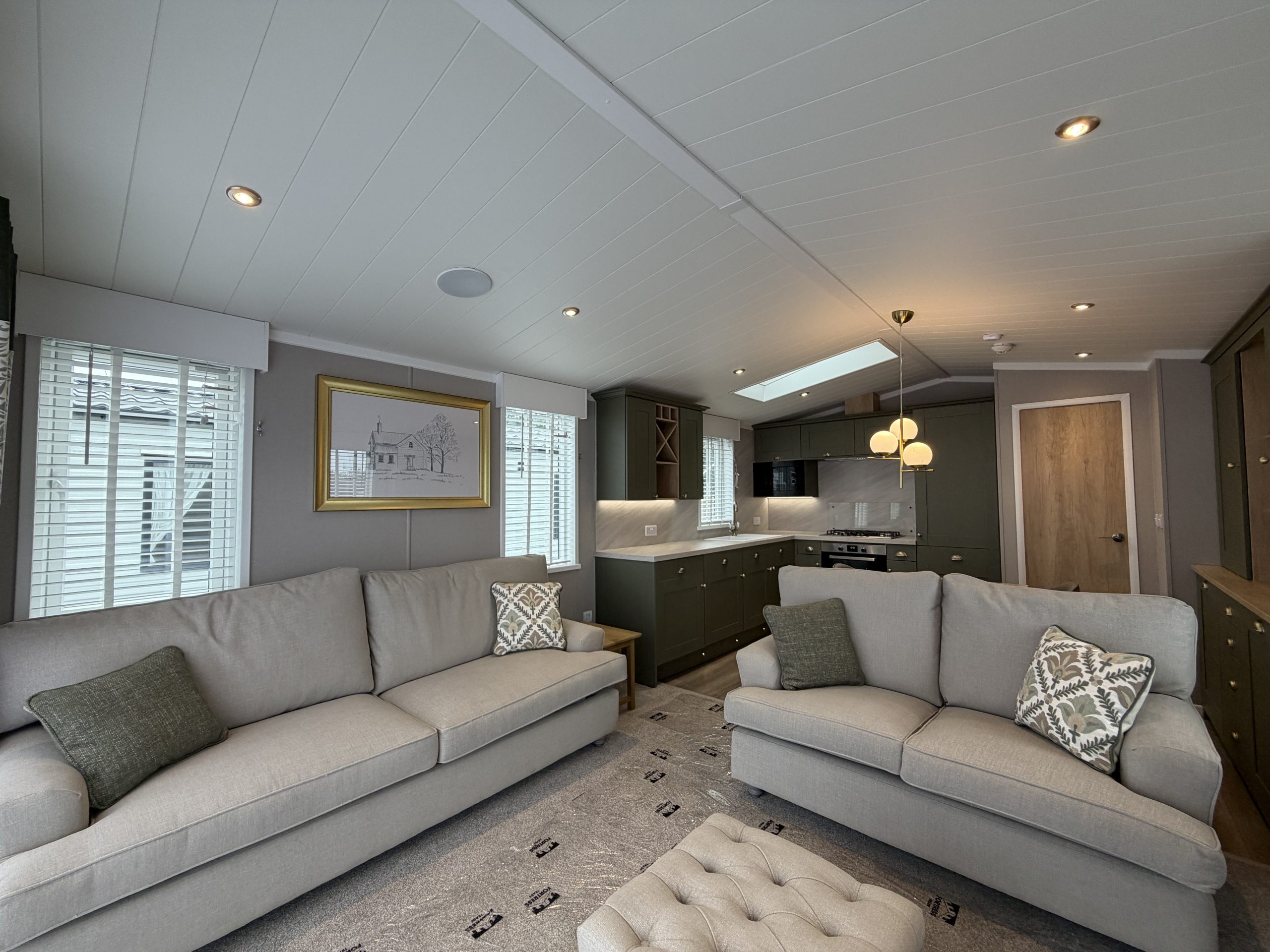 Photograph of the living area with free standing furniture in the Swift Vendee Lodge 2026 at Broadwater Holiday Park, Partington's