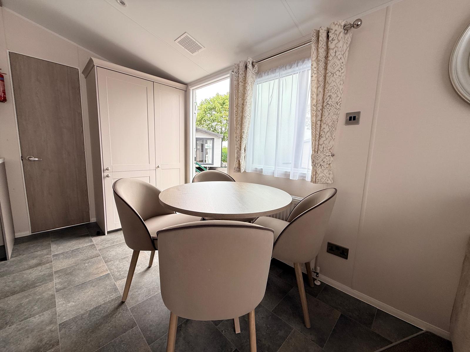 An image showing the dining area of the Willerby Salisbury 2027 model holiday home. For sale at Newton Hall Holiday Park