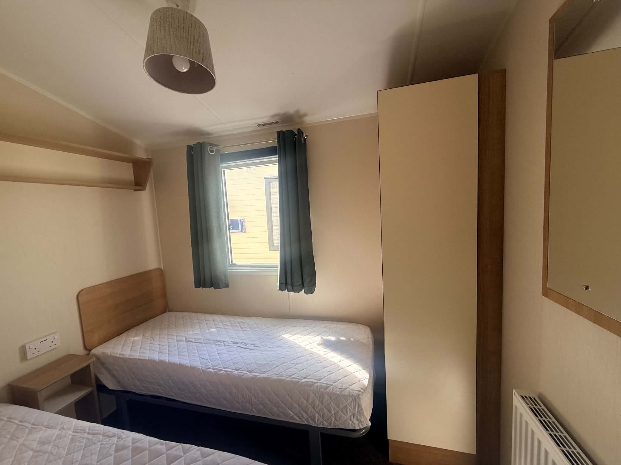 The second bedroom or guest room feature twin beds in the Willerby Mistral 2017